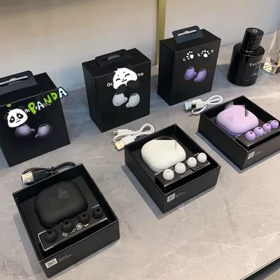 Boxed wireless earbuds in charging cases, white, black and lilac